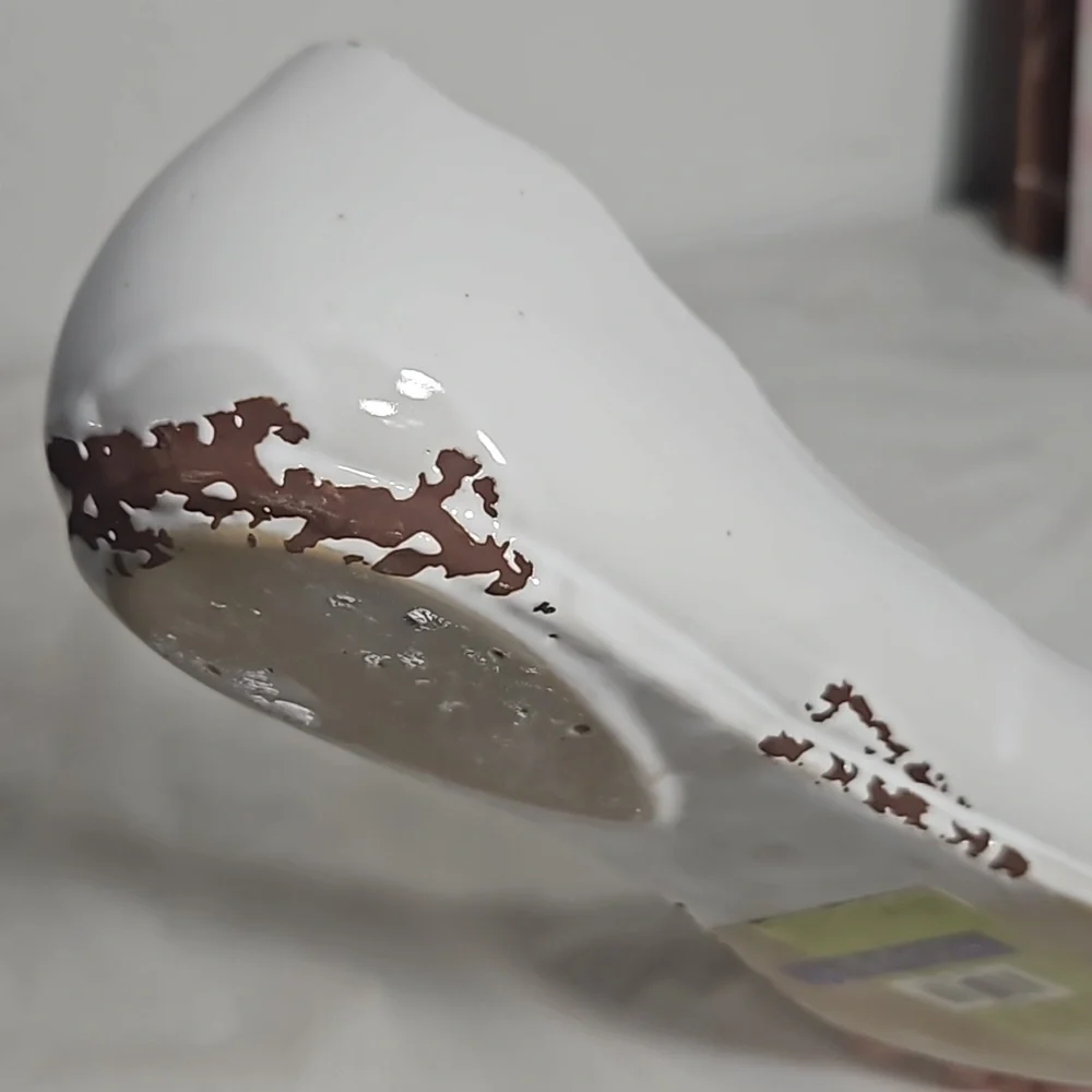 Decorative ceramic ballet shoe vase with vine design